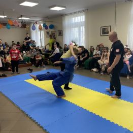 Sportowcy podczas ćwiczeń na macie.