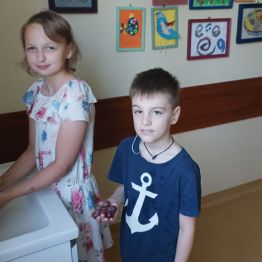 Zuzia i Tima myją owoce.