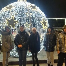 wychowanki stoją przed iluminacja świąteczną