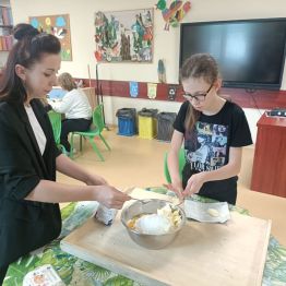 Karolinka z Wychowawcą dodają składniki do miski na ciasteczek. 