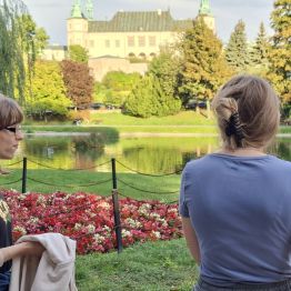 Dziewczynki w parku podziwiają  otaczącą je przyrodę.