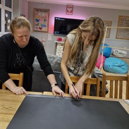 Wychowanka wycina elementy z papieru