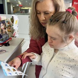 Kasia i Jej mama stoją przy okienku. Mama pomaga Kasi dokonać wyboru najpiękniejszego znaczka. 