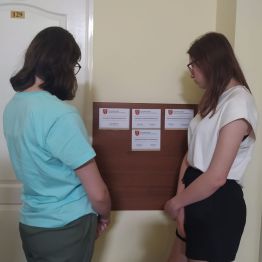 uczniowie stoją i zastanawiają się gdzie załatwić sprawę urzędową