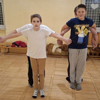 Wychowankowie trzymają się za dłonie i tworzą samolot.